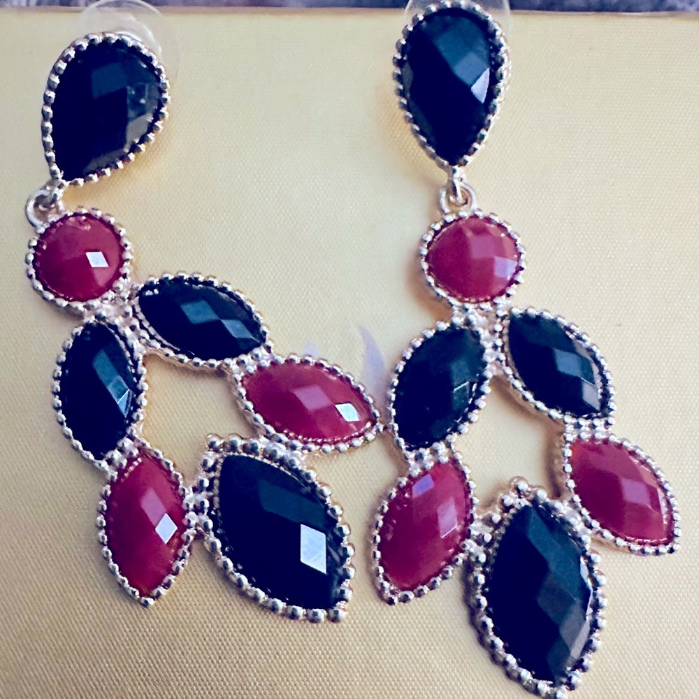 A pair of burgundy and black pierced earrings. Great for any occasion, like new